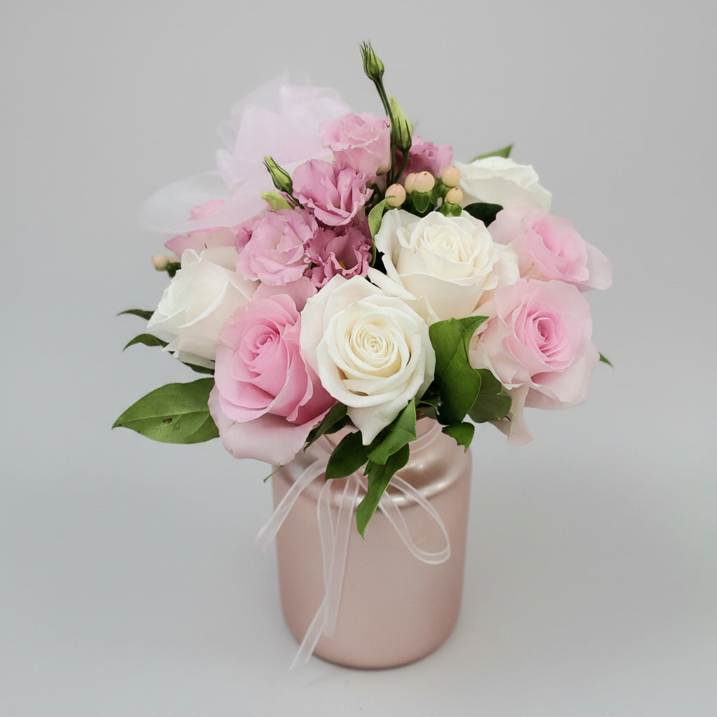 Bouquet of pink, white roses and other pinin a pink vase and white flowers